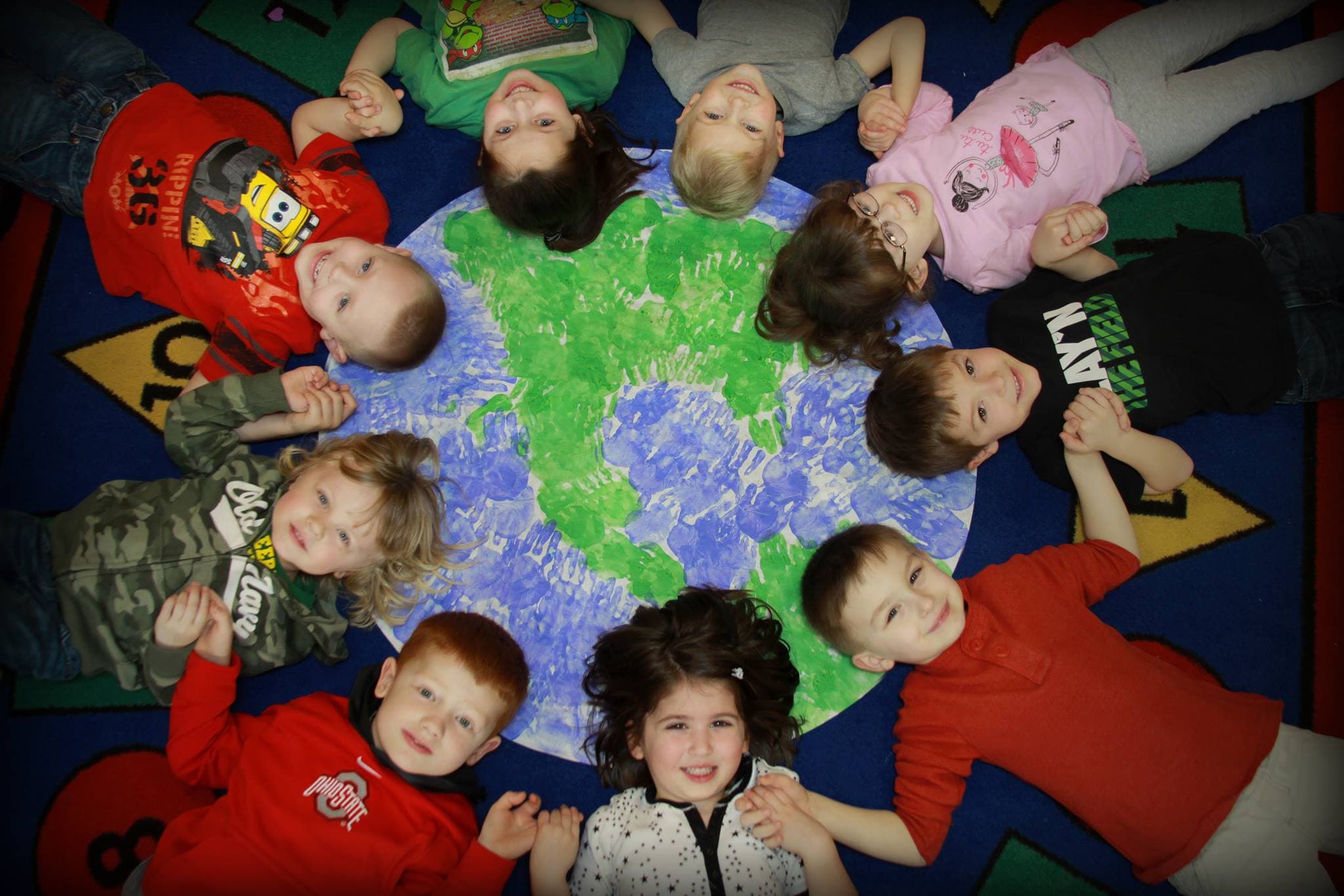 Creation Station children gathered around a classroom art project