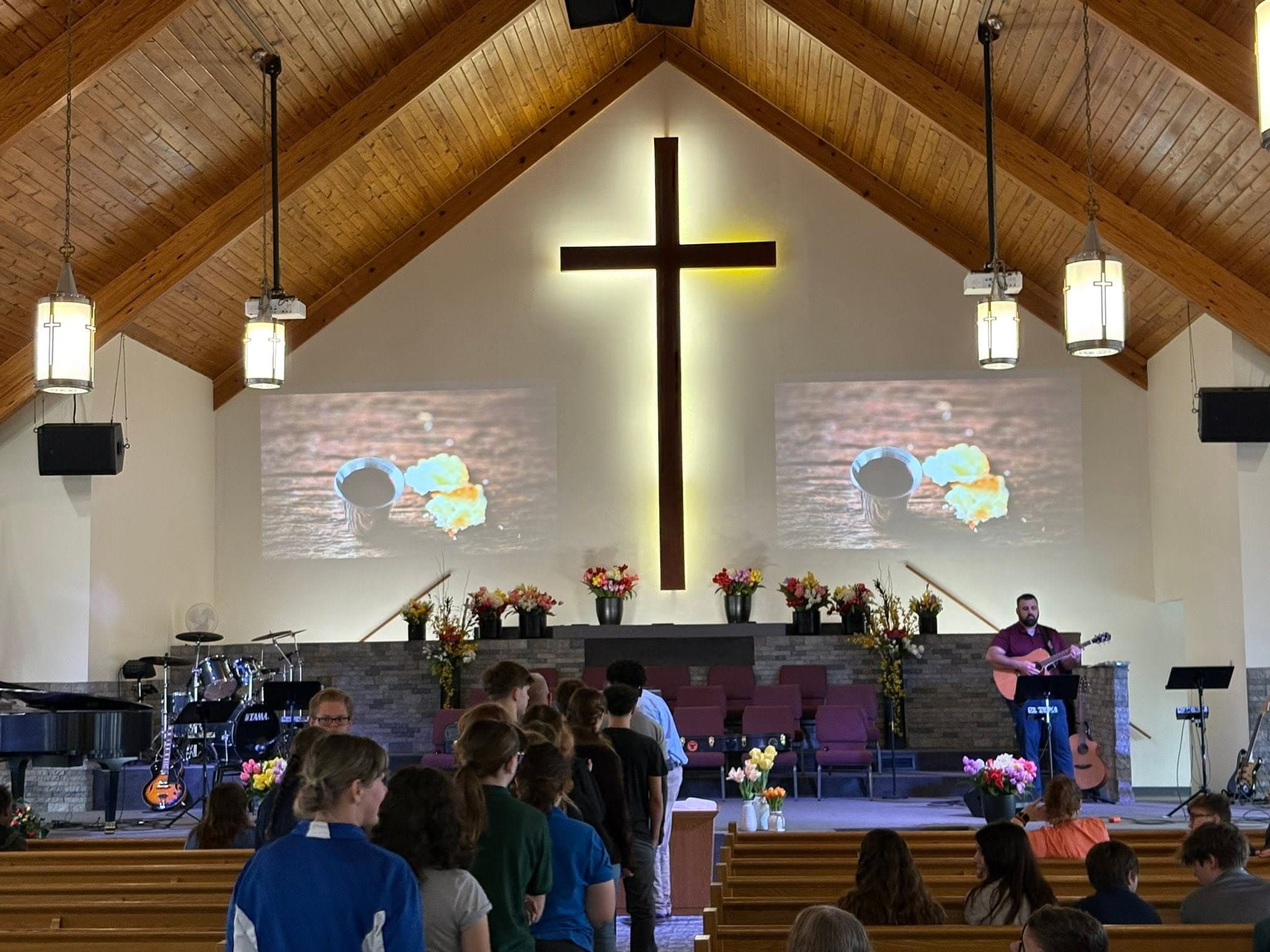 CCA students gathered for chapel beneath the sanctuary cross