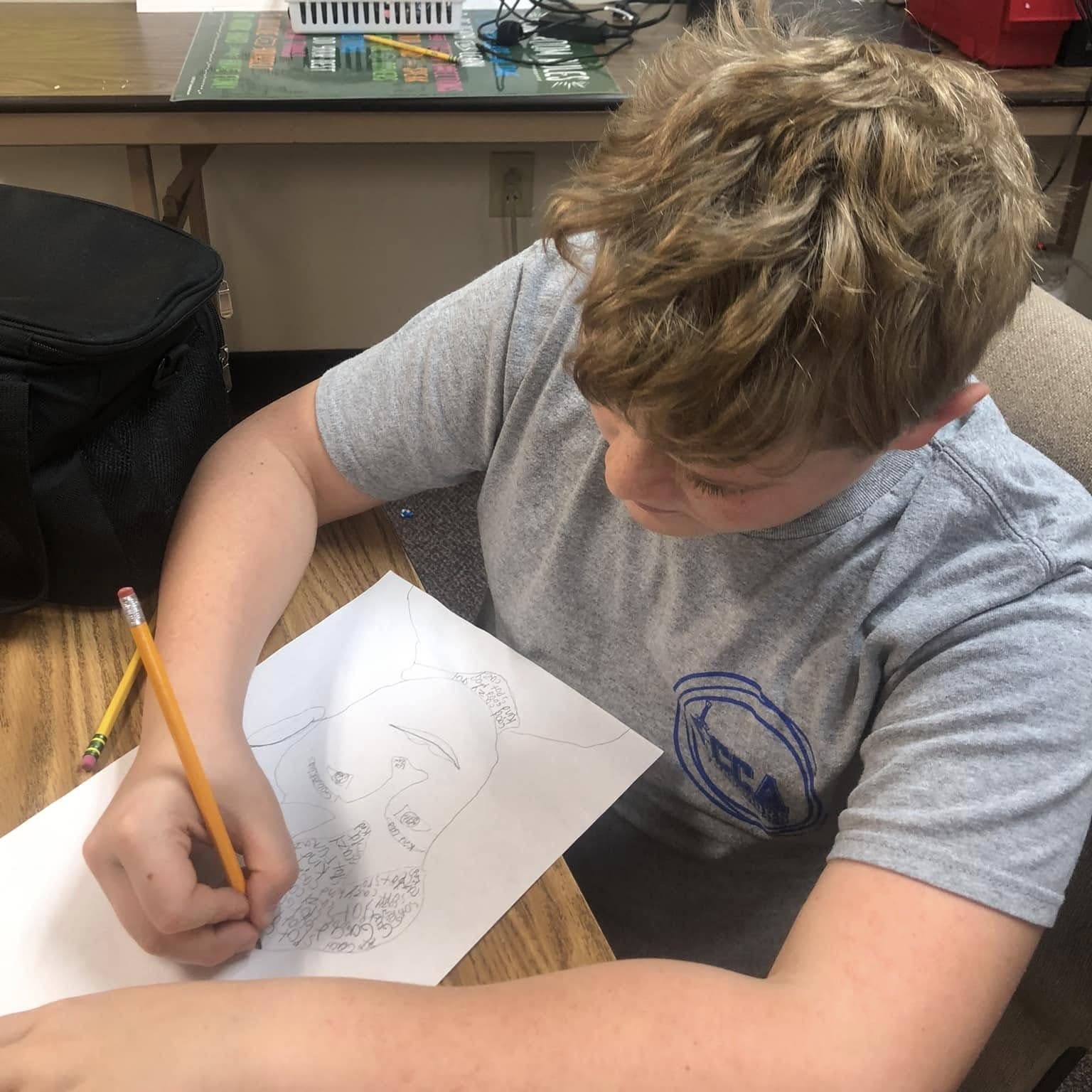 A CCA high school student focused on classroom work